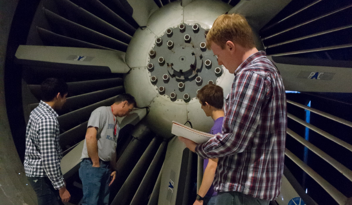 AOE students with a large turbine.