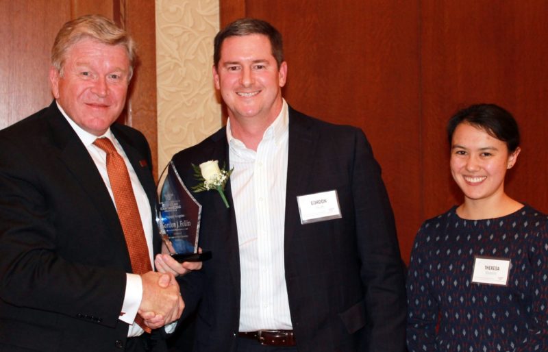 Gordie Follin accepts his award from Eric Paterson and Theresa Blandino