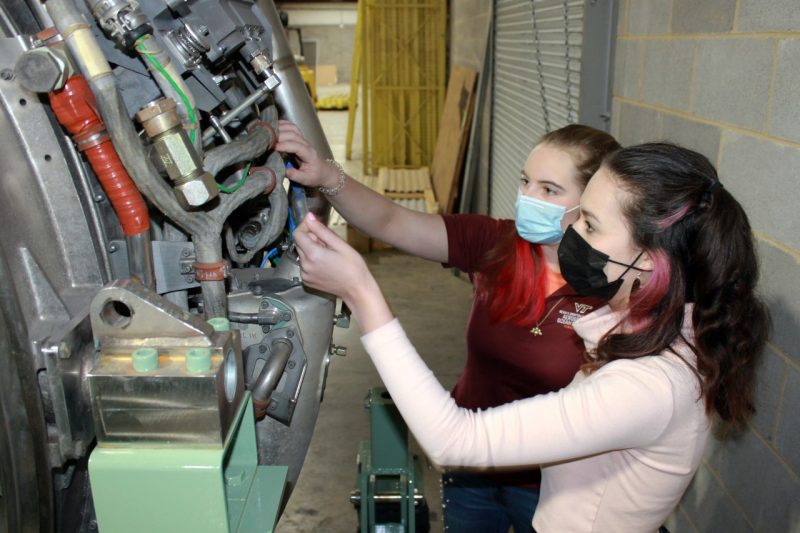 Students inspect the new PW6000 engine, donated to the university by Pratt & Whitney. 
