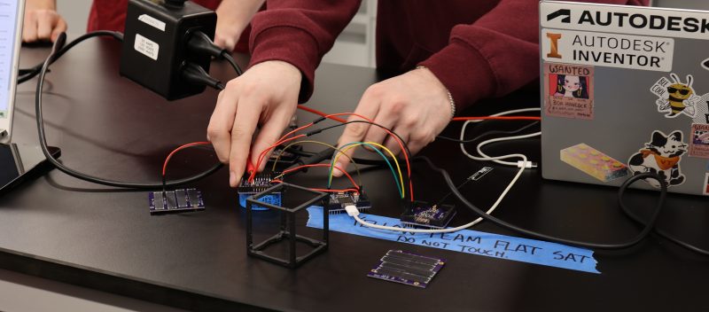 Student working on nanosatellite
