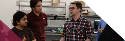 two students and Brad Denby discuss nanosatellites in class