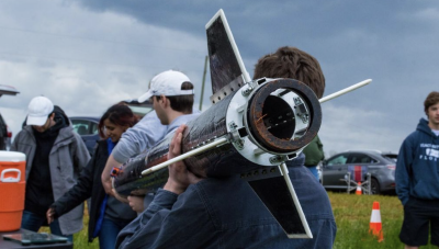 backend of a rocket on shoulders of team