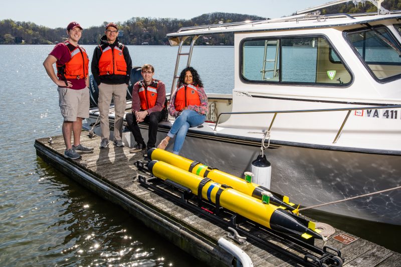 graduate students and professor Dan Stilwell at Claytor Lake, for testing of autonomous underwater vehicle