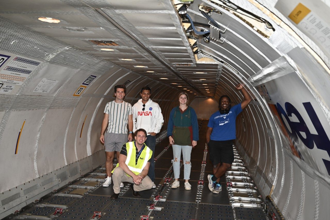 Students examining the 757 cargo-deck and cargo handling system