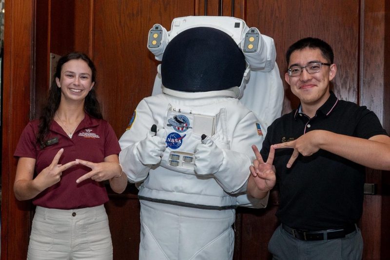 Maggie Campbell and Kevin Xu with astronaut mascot