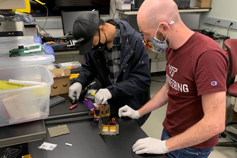 Students at Space@VT prepare their satellite for preflight testing.