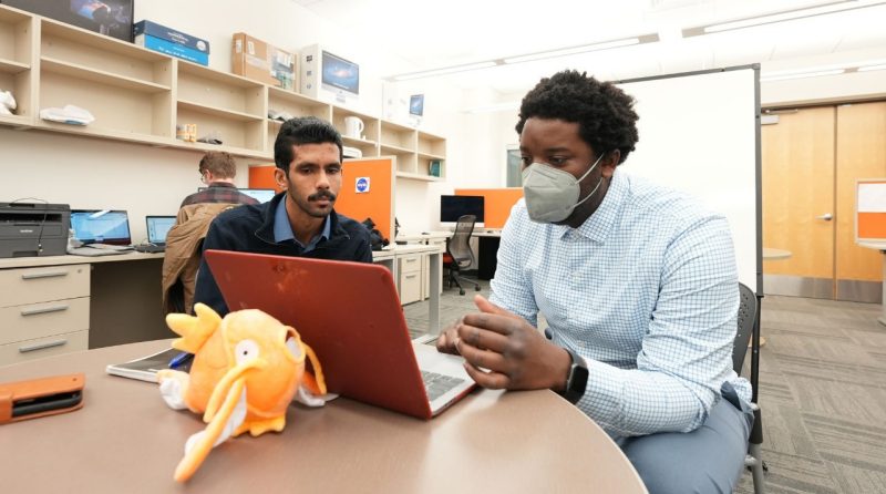 Master's student Edwin George discusses the specifics of research with Assistant Professor John Palmore. 